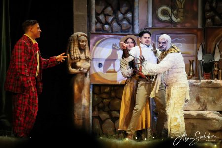 Scene from the pantomime "Il-Mummja" showcasing actors in costume during a theatrical performance. Actors performing in "Il-Mummja" pantomime at Fondazzjoni Teatrali.