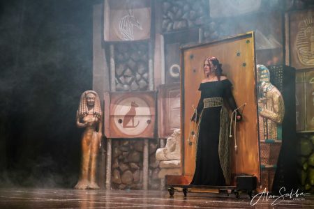 A performer in a pantomime titled "Il-Mummja" at Fondazzjoni Teatrali Silvio Fleri Soler, showcasing Egyptian motifs and storytelling. Performing actress in Egyptian-themed pantomime scene with ancient props and costumes.
