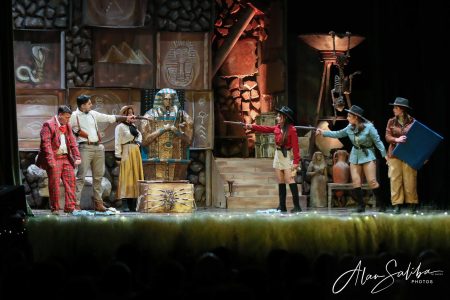 Actors perform a pantomime scene on stage, depicting a humorous and lively theatrical moment. Pantomima - Il-Mummja scene with actors in costume.