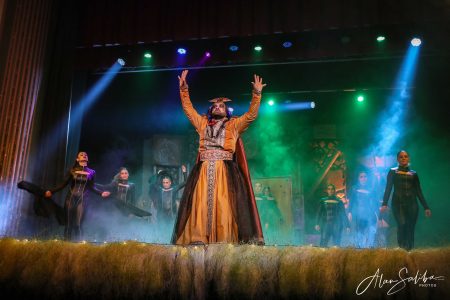 A theatrical performance featuring actors in costume during the pantomime "Il-Mummja". Performer in Pantomima - Il-Mummja on stage with dramatic lighting.
