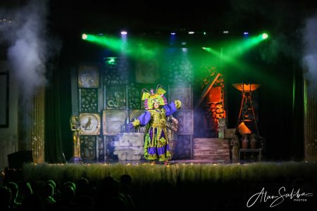 A vibrant puppet character performs in a theatrical pantomime titled "Il-Mummja" at Fondazzjoni Teatrali Silvio Fleri Soler. Colourful puppet on stage during a theatrical performance.