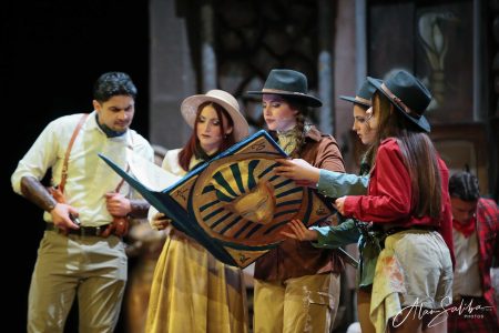 Performers in costume practicing a scene from the pantomime "Il-Mummja" at the theatre. Actors rehearsing a pantomime scene on stage.