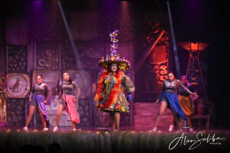 A vibrant scene from the pantomime "Il-Mummja" featuring performers in colorful costumes. Performing "Il-Mummja" pantomime on stage.