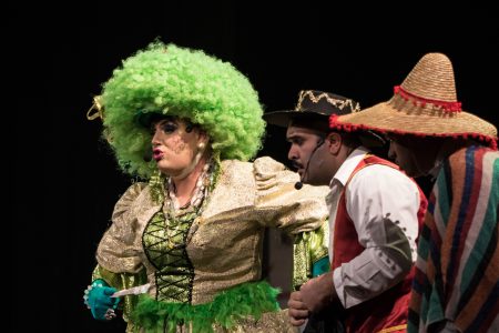 A scene from the Zorro pantomime featuring performers in elaborate costumes and expressive gestures during a theatrical show. Colourful Zorro characters in lively theatrical act on stage.