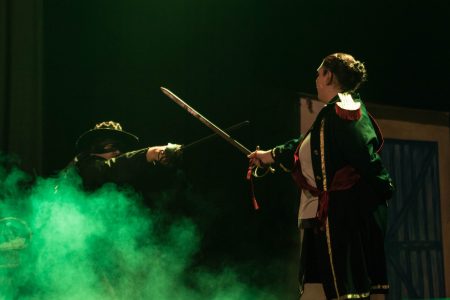 Actors perform a dramatic sword fight scene from Zorro at the Fondazzjoni Teatrali Silvio Fleri Soler. Zorro and opponent engaging in sword fight during pantomime performance.