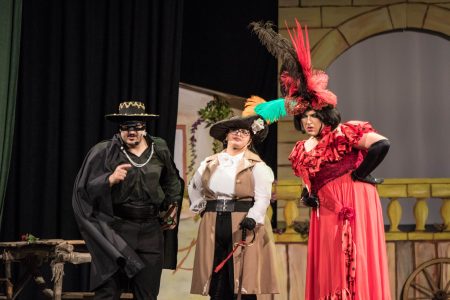 Performers dressed as Zorro characters during a theatrical pantomime. Actors in colourful Zorro-themed costumes perform on stage.