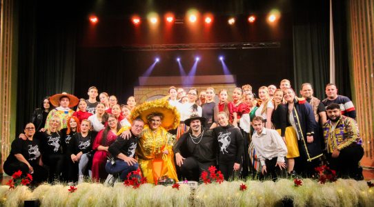 Group photo of actors and performers after the Zorro pantomime performance on stage. Performers in Zorro pantomime on stage with costumes and props.