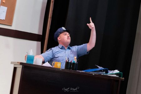Actor in costume gesturing passionately during a theatrical performance at Fondazzjoni Teatrali Silvio Fleri Soler. Actor performing on stage during a theatrical play at Fondazzjoni Teatrali.