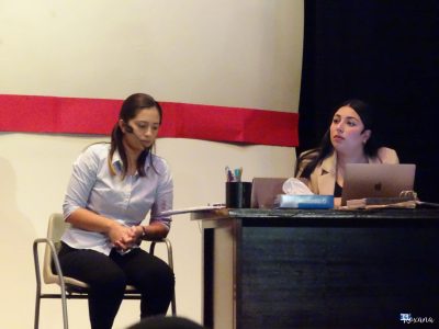 A scene from a comedy show at Fondazzjoni Teatrali Silvio Fleri Soler, featuring two women on stage with a minimal set. Young women performing on stage during a comedy night.