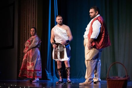 Actors in traditional Maltese costumes performing a scene during a theatre production. Actors performing a traditional Maltese theatre scene on stage.