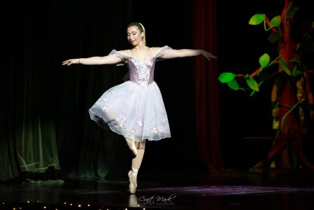 A young ballerina in a pastel tutu gracefully dances on stage, showcasing her talent during a performance at Fondazzjoni Teatrali Silvio Fleri Soler. Ballet dancer in a tutu performing on stage during a dance recital at Fondazzjoni Teatrali.