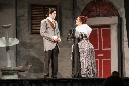 Actors in period costumes engage in a dramatic moment on stage, with a theatrical backdrop and set design. A scene from the pantomime "Korps Brajd" performed at Fondazzjoni Teatrali Silvio Fleri Soler.