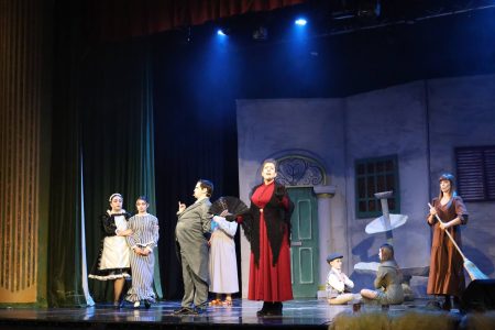 A scene from the pantomime "Korps Brajd" featuring actors in period costumes performing on stage. Pantomima - Korps Brajd, theatrical performance on stage.
