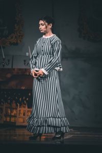 A performer in striped costume during a pantomime show at Fondazzjoni Teatrali Silvio Fleri Soler. A young woman performing in a theatrical pantomime, dressed in a striped costume on stage.