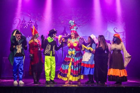 A lively scene from the pantomime "Korps Brajd" featuring actors in vibrant costumes on stage. Performers in colourful costumes during Pantomima - Korps Brajd.